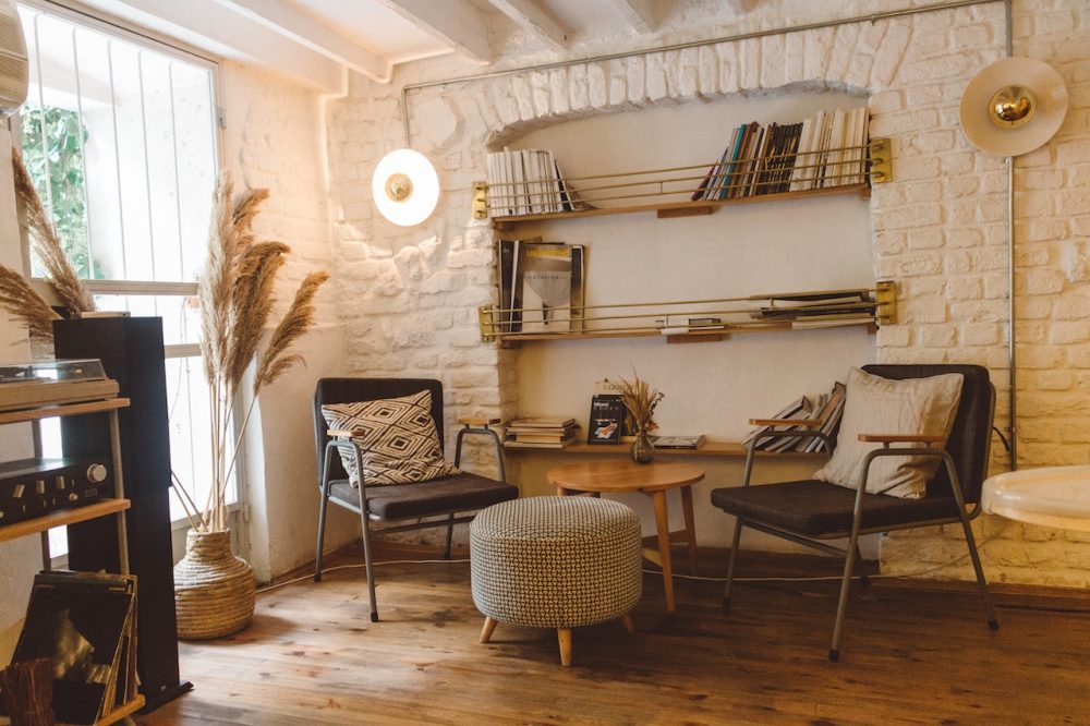 Example of work by remodeling contractor for home additions. Added living space with sofas and book shelves on the wall. Yellow toned walls.
